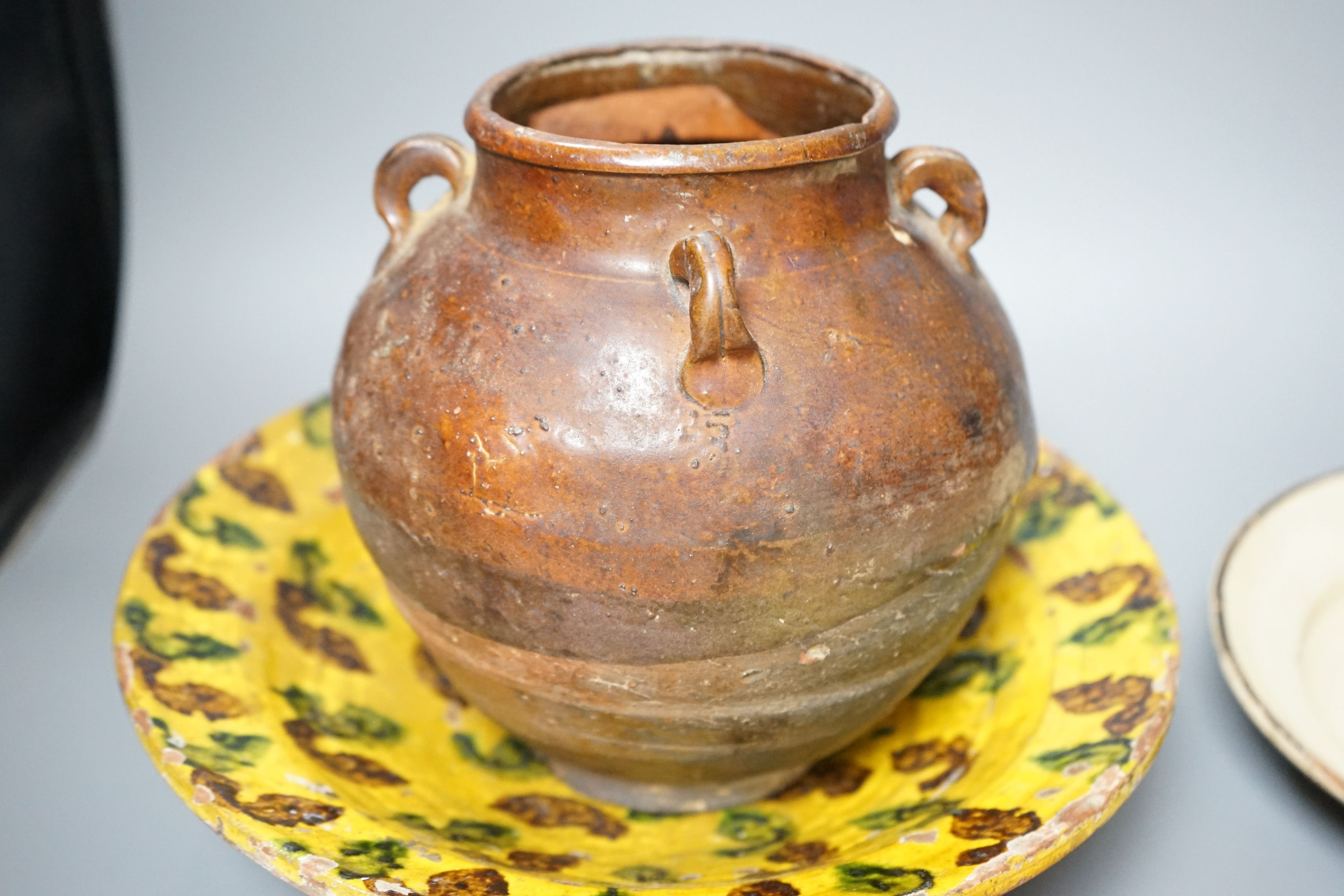 A group of 19th/20th century Continental pottery items to include two sponge ware dishes and a partially glazed jar, largest 20cm, (6)